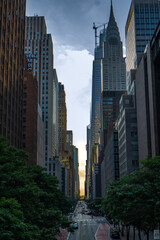 Obraz premium Above view on a new york city street. Skyscrapers, commercial and residential buildings. Trees area