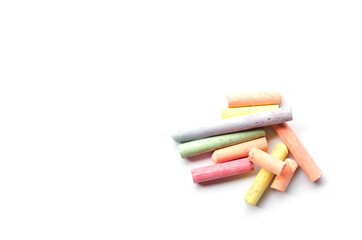 chalks in a variety of colors arranged on a white background