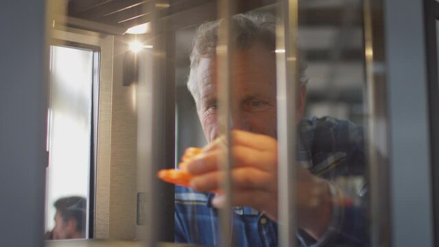 Mature male college student studying engineering using 3D printing machine - shot in slow motion