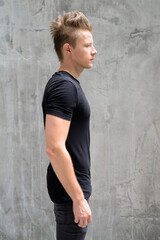 Fototapeta premium Profile view of handsome man with blond hair outdoors