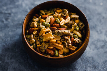 plant-based food, vegan nuts and legumes snack mix in wooden bowl