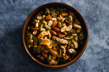 plant-based food, vegan nuts and legumes snack mix in wooden bowl
