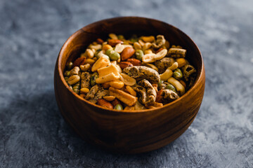 plant-based food, vegan nuts and legumes snack mix in wooden bowl