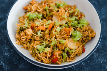plant-based food, vegan ginger noodles with stir fry vegetables and grated celeri