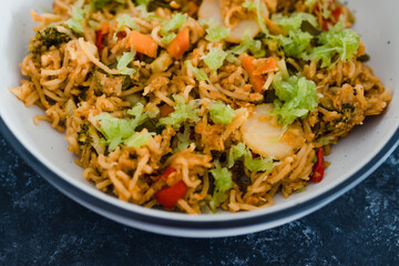 plant-based food, vegan ginger noodles with stir fry vegetables and grated celeri