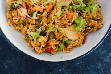 plant-based food, vegan ginger noodles with stir fry vegetables and grated celeri