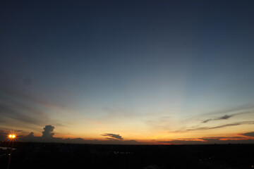 Dramatic atmosphere panorama aerial view of beautiful freshness summer twilight sky background at countryside of Thailand with shiny light and silhouette landscape.