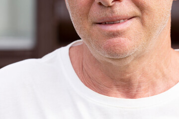 Fototapeta premium The chin of an unshaven smiling man