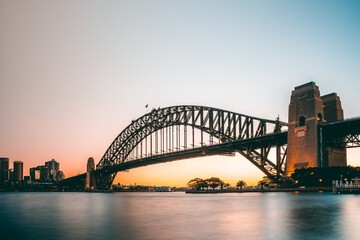 Beautiful sunset view of iconic sydney harbour bridge from north sydney side when the sun goes down and the sky light up in australia