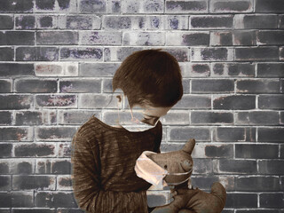 Boy and his teddy wearing mask