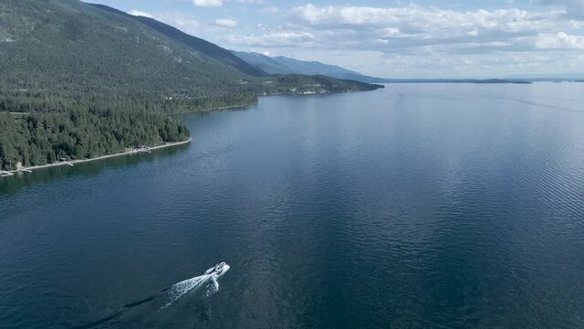Fresh Water Lake with Boaters Enjoying Summer Day in Kalispell, Montana - Aerial Drone