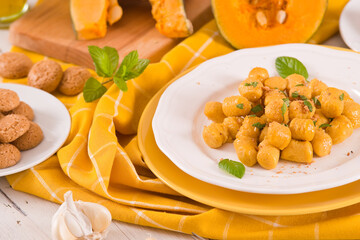Pumpkin gnocchi with grated amaretti cookies.	