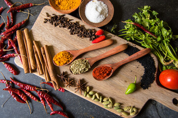 Variety of Indian spices on a wooden platter with use of selective focus