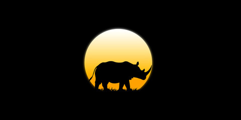 Rhino walks in the dark moonlight in the darkness