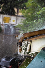 the edge of the roof in the rain