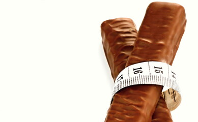 chocolate with tape measure on white background stock photo