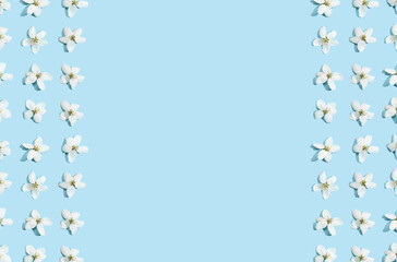 Apple tree floral frame. Bright summer background. Spring white fruit flowers. Repeat spring texture. Creative trend composition. Many springtime elements. Blank may layout. Horizontal banner. Blue