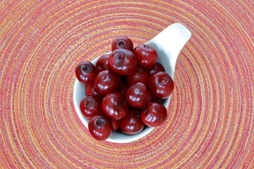 cherries in a bowl top view, in background colorful vibrant circles