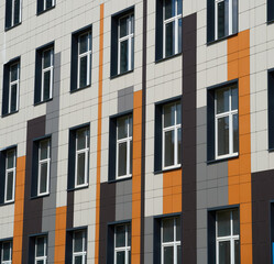 facade of a modern building on a bright Sunny day, siding and Windows, beautiful exterior of the new building