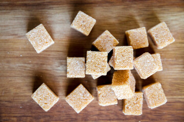Brown cane sugar cubes on a cutting board