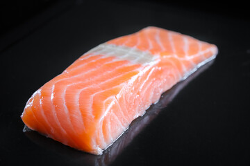 Salmon steak isolated on black background