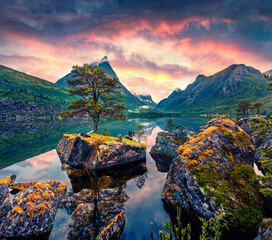 Fantastic summer outdoor csene. Calm waters of Innerdalsvatna lake. Colorful sunrise on Norway,...