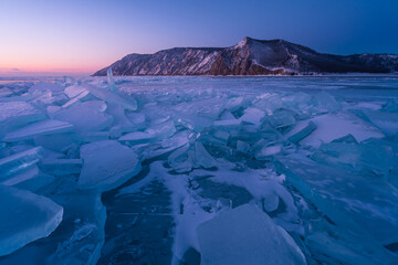 Forzen lake Baikal in winter season at sunrise view from Uzury bay, crack on smooth surface of ice,...