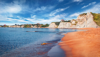 Wonderful summer landscape of famous Xi Beach. Stunning morning scene of Cephalonia island, Greece, Europe. Marvelous seascape of Ionian Sea. Traveling concept background.