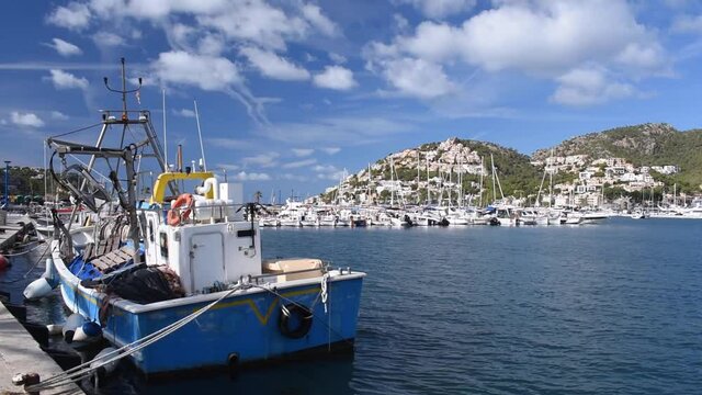 Port d'Andratx Majorca a working boat with winch moored and a view across the bay of the main marina area on a warm and beautiful day.