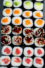 Japanese food. Rolls with ripe avocado, red fish, salmon, fresh rice with vegetables in nori. Set with rolls