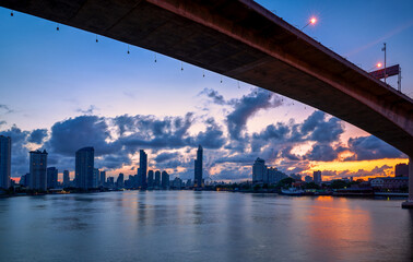 Fototapeta premium bangkok sunrise cityscape with chao praya river and high bridge for transportation