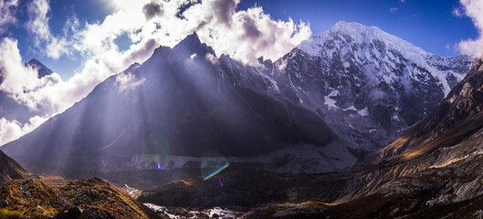 Panorama of Langtang mountain with beams of sunlight in Langtang National Park in Nepal.