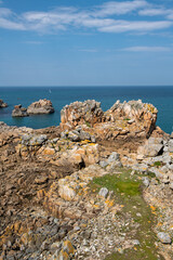 Fototapeta na wymiar The beautiful coast made of warm yellow rocks in northern Brittany with the Atlantic ocean