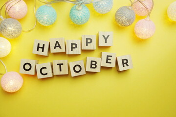 Happy October alphabet letter with LED Cotton ball Decoration on yellow background