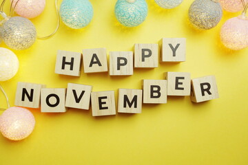 Happy November alphabet letter with LED Cotton ball Decoration on yellow background