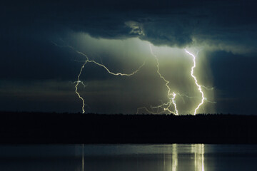 several lightning strikes during a strong thunderstorm over the lake