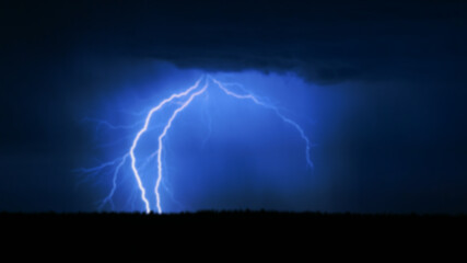 Naklejka na ściany i meble several lightning strikes during a strong thunderstorm over the lake