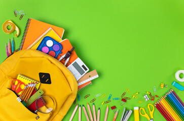 School backpack isolated on green background.