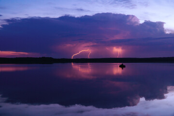 several lightning strikes during a strong thunderstorm over the lake