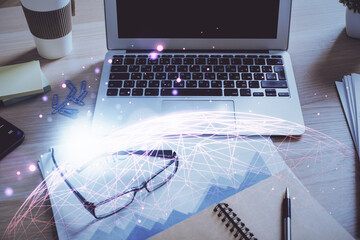 Computer on desktop with social network hologram. Double exposure. Concept of international people connections.