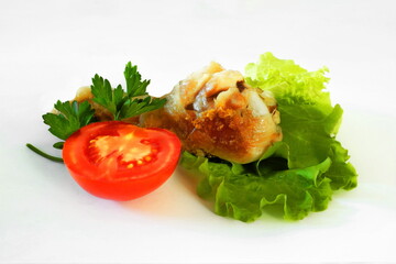 Fried chicken legs with tomato and herbs on white isolated background