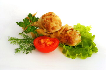 Fried chicken legs with tomato and herbs on white isolated background