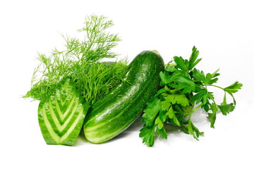 Cucumbers and bunches of greens on white isolated background