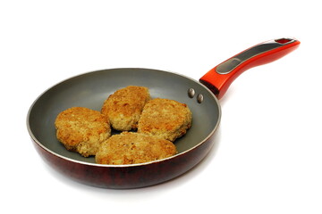 Meat cutlets in a frying pan. Isolate on white.