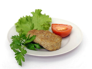 Meat cutlet with tomato and salad. Isolate on white.