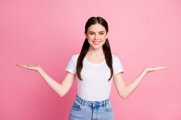 Portrait of her she nice-looking attractive lovely pretty content glad cheerful cheery girl holding on palms copy space ad advert tips feedback isolated over pink pastel color background