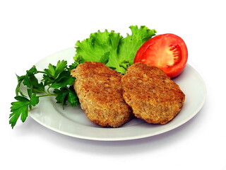 Meat cutlet with vegetables on a plate. Isolate on white.