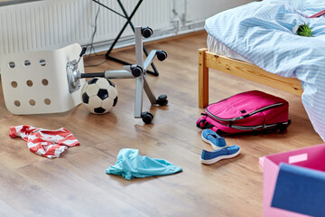 mess, disorder and interior concept - view of messy home kid's room with scattered stuff