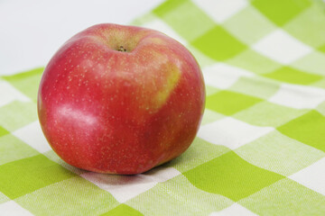 Apple on a kitchen towel. Red apple fruit isolated on white background. Kitchen towel