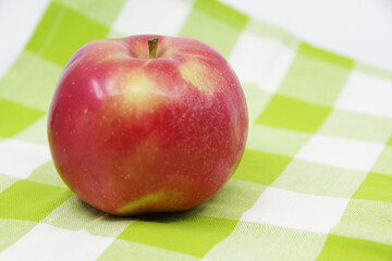 Apple on a kitchen towel. Red apple fruit isolated on white background. Kitchen towel